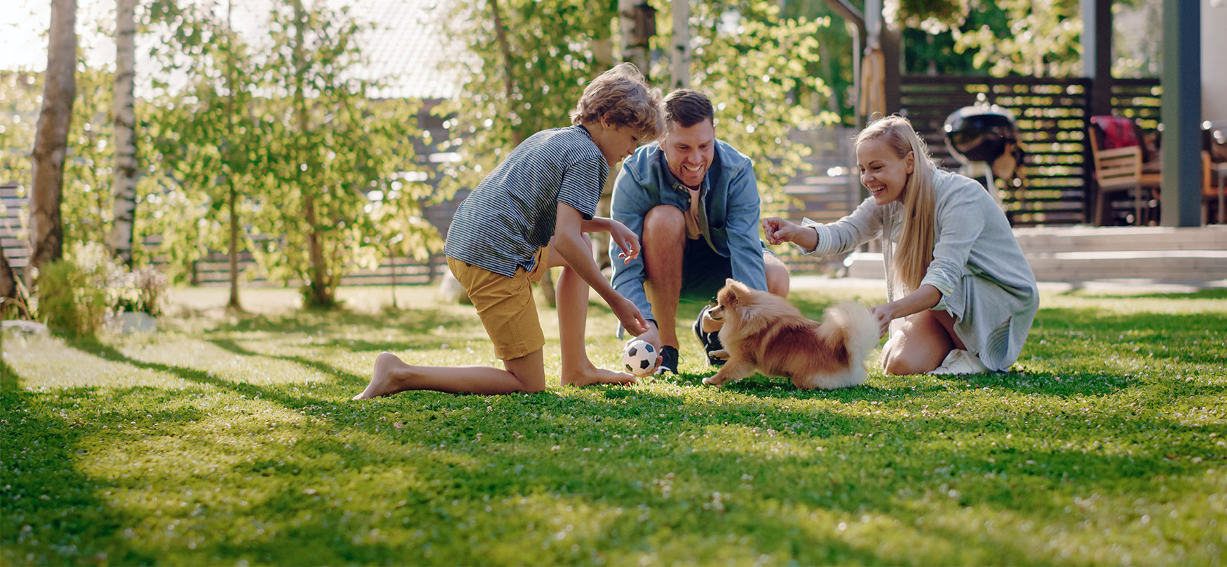 Family in Backyard Playing with Dog